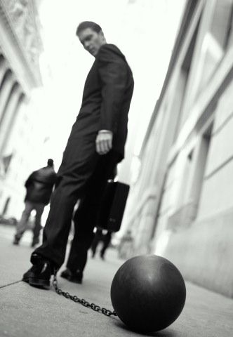 guy with briefcase and with prison ball chain on left leg